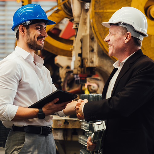 business man and Factory engineer talking and shaking hands